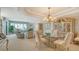 Formal dining room and living area with stylish furniture and waterfront views at 350 Gulf Of Mexico Dr # 211, Longboat Key, FL 34228