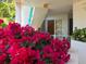 Inviting entrance with colorful flowers, leads into a serene and well-maintained building with an 'EXIT' sign at 350 Gulf Of Mexico Dr # 211, Longboat Key, FL 34228