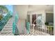 Front entrance to the condo unit with a private staircase and plants at 350 Gulf Of Mexico Dr # 211, Longboat Key, FL 34228
