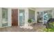 Inviting front porch with tile flooring, seating area and decorative door at 350 Gulf Of Mexico Dr # 211, Longboat Key, FL 34228