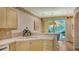 Kitchen features light wood cabinetry, tile countertops, and a breakfast bar at 350 Gulf Of Mexico Dr # 211, Longboat Key, FL 34228