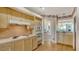Kitchen with light wood cabinets, tile backsplash, and stainless steel appliances at 350 Gulf Of Mexico Dr # 211, Longboat Key, FL 34228