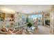 Comfortable living room with a fireplace and large windows providing natural light at 350 Gulf Of Mexico Dr # 211, Longboat Key, FL 34228