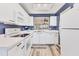 Efficient white kitchen with modern appliances and wood-look flooring at 3750 Pinebrook Cir # 404, Bradenton, FL 34209
