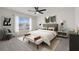 Modern bedroom with stylish decor, comfortable bed, and large window at 4108 Silver Strand Trl, Palmetto, FL 34221