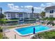 Inviting community pool with surrounding lounge chairs at 4330 Falmouth Dr # 308, Longboat Key, FL 34228