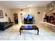 Living room with a stone fireplace and a large TV at 5630 3Rd W St, Bradenton, FL 34207