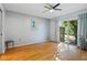 Bedroom with hardwood floors, ceiling fan, and sliding glass doors to patio at 608 N Jefferson Ave # 30, Sarasota, FL 34237