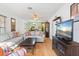 Open living room with hardwood floors, sofas, and flat-screen TV at 608 N Jefferson Ave # 30, Sarasota, FL 34237