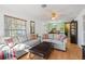 Spacious living area with hardwood floors, sofas, and view into dining area at 608 N Jefferson Ave # 30, Sarasota, FL 34237