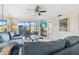 Comfortable living room with gray sofa, armchair, and large sliding glass doors at 6191 Timber Lake Dr # A5, Sarasota, FL 34243