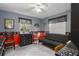 Cozy bedroom with a futon, dresser, and window coverings at 6919 64Th E Ave, Palmetto, FL 34221