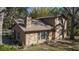 Two-story house with stone and wood siding, a brown door, and large windows at 6919 64Th E Ave, Palmetto, FL 34221