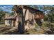 Two-story house with stone and wood siding, a balcony, and large windows at 6919 64Th E Ave, Palmetto, FL 34221