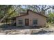 Two-story house with stone and wood siding, a brown door, and large windows at 6919 64Th E Ave, Palmetto, FL 34221