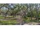 Landscaped front yard with mature trees and a long driveway at 6919 64Th E Ave, Palmetto, FL 34221