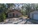 Two-story house with covered porch and mature landscaping, near a storage shed at 6919 64Th E Ave, Palmetto, FL 34221