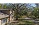 View of a house exterior and surrounding yard with mature trees at 6919 64Th E Ave, Palmetto, FL 34221