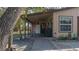 Tan house with covered porch and walkway, near trees at 6919 64Th E Ave, Palmetto, FL 34221