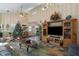Spacious living room featuring a large TV, comfortable seating, and a cozy fireplace at 6919 64Th E Ave, Palmetto, FL 34221