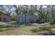 Tan metal storage shed with a roll-up door at 6919 64Th E Ave, Palmetto, FL 34221