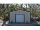 Tan metal storage shed with a roll-up door at 6919 64Th E Ave, Palmetto, FL 34221