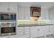 Sleek kitchen with white cabinets, stainless steel appliances, and decorative backsplash at 7056 Saddle Creek Ln, Sarasota, FL 34241