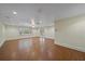 Spacious living room with wood-look tile floors, recessed lighting, ceiling fan, and large window at 7056 Saddle Creek Ln, Sarasota, FL 34241