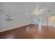 Bright and airy main bedroom with wood-look tile, ceiling fan, and multiple windows at 7056 Saddle Creek Ln, Sarasota, FL 34241