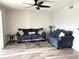 Living room with a couch and two chairs, ceiling fan and wood-look flooring at 7301 29Th Avenue W Dr # 206, Bradenton, FL 34209