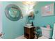 Charming bathroom with teal walls and a round mirror at 7402 Westmoreland Dr, Sarasota, FL 34243