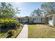 House exterior featuring a walkway, landscaping and a charming front porch at 7402 Westmoreland Dr, Sarasota, FL 34243