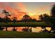 Peaceful view of sunrise over a tranquil golf course at 7461 W Country Club Dr. N N # 106, Sarasota, FL 34243