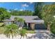 Single-story home with gray roof, stone accents, and palm trees at 7707 10Th Nw Ave, Bradenton, FL 34209