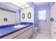 Light blue bathroom with blue tile countertops, and a shower/tub combo at 7707 10Th Nw Ave, Bradenton, FL 34209
