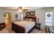 Spacious bedroom with large bed, nightstand, and window coverings at 7707 10Th Nw Ave, Bradenton, FL 34209
