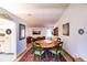 Charming dining room with round table and green chairs, features a red rug and art at 7707 10Th Nw Ave, Bradenton, FL 34209