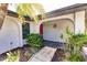 Red door entryway with walkway and tropical landscaping at 7707 10Th Nw Ave, Bradenton, FL 34209