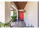 Front entrance with red door, arched entry, and wood ceiling at 7707 10Th Nw Ave, Bradenton, FL 34209