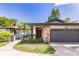 Single-story home with stone accents, gray garage door, and red front door at 7707 10Th Nw Ave, Bradenton, FL 34209