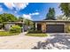 House exterior featuring a stone facade and a two-car garage at 7707 10Th Nw Ave, Bradenton, FL 34209