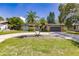 Single-story home with gray garage door, stone accents, and circular driveway at 7707 10Th Nw Ave, Bradenton, FL 34209