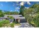 Single-story home with gray garage door and a red front door at 7707 10Th Nw Ave, Bradenton, FL 34209