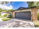 Gray garage door and stone facade on a single story home at 7707 10Th Nw Ave, Bradenton, FL 34209