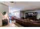 Living room features hardwood floors, a large leather sofa and a built-in entertainment center at 7707 10Th Nw Ave, Bradenton, FL 34209