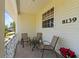 Covered front porch with seating area and holiday decorations at 8139 Alan Blvd, Punta Gorda, FL 33982