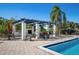 Covered outdoor kitchen and dining area by the pool at 920 Tidewater Shores Loop # 202, Bradenton, FL 34208