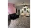 Living room featuring gray wood-look floors, white brick feature wall, and comfy seating at 9641 Fulton Ave, Hudson, FL 34667