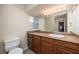 Clean bathroom with wood cabinets, single sink vanity, and tile flooring at 1010 Southern Pine Ln, Sarasota, FL 34243