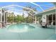 Inviting kidney-shaped pool with screened enclosure at 11528 28Th Street E Cir, Parrish, FL 34219